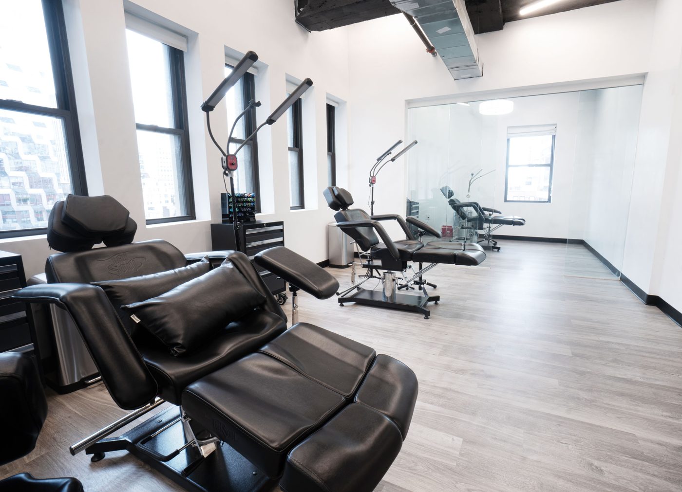 Penthouse studio interior with tattoo stations and natural light